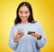 Woman with smartphone, credit card and ecommerce with smile and online shopping on yellow studio background. Fintech