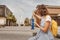 Woman with smartphone pointing at the largest Ferris wheel in the world - Dubai Eye. Top tourist attractions and sightseeing in