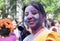 Woman smeared with blue and pink colours enjoying Holi