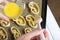 A woman smears an egg on curls stuffed with poppy and walnuts. For baking