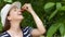 Woman smelling cherries.