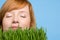 Woman smelling grass