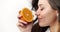 Woman Smelling Sliced Orange Isolated on White