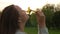 Woman smells field flowers, face and dandelions close up