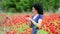 Woman smells flowers in a field