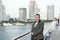 Woman smile in business jacket on shipboard in miami, usa. Sensual woman on ship board on city skyline. Fashion, beauty