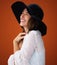 Woman, smile and hat with studio for fashion with laugh, trendy and memory for outfit for expression style inspiration