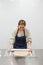 Woman smiling as she kneads dough with kneading stick