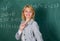 Woman smiling educator classroom chalkboard background. Working conditions for teachers. She likes her job. Back to