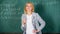 Woman smiling educator classroom chalkboard background. Working conditions which prospective teachers must consider
