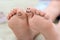 Woman with smiling faces drawn on toes, closeup of foot