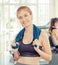 Woman smiling with friend work out in the background