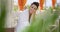 Woman smiling outdoors at seaside restaurant