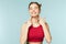 Woman smiling with perfect smile on the blue studio background