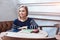 Woman smiling - portrait of happy lovely and beautiful woman in casual clothes indoor sitting in cafe