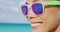 Woman smiling on summer beach wearing sunglasses