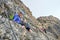 Woman smiling on via ferrata Cesare Piazzetta to Piz Boe peak, Dolomites mountains, Italy. Summer adventure tour