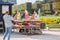 Woman snaps photo of toy sailboats on cart in Luxembourg Garden, Paris