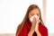 Woman sneezes holding a handkerchief nasal