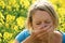 Woman sneezing because of allergy to pollen