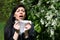 Woman sneezing among flowers