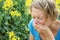 Woman sneezing because of pollen