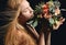 woman sniff vintage rustic bouquet of wild roses Carnation flower