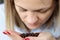 Woman is sniffing coffee grains on her palm