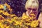 Woman sniffing flowers Heliopsis pensioner in the garden. Photo toned.