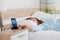 Woman Snoozing Alarm On Mobile Phone