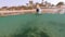 Woman snorkel swim in shallow water with coral fish