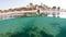 Woman snorkel swim in shallow water with coral fish, Red Sea, Egypt