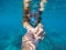 Woman snorkeling in blue sea