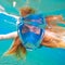 Woman snorkeling in full face mask. Female snorkel in clean turquoise sea.