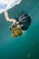 woman snorkeling with Martigias Papua Jellyfish, Jellyfish Lake