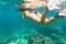 Woman snorkelling over floor of tropical sea