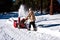 Woman snow blowing