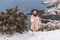 Woman snow sea. Amidst a wintry backdrop, a woman in a beige faux fur coat gleefully engages in a snowball fight, adding