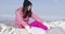 Woman with snowboard relaxing on mountain