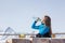 Woman snowboarder drinking water outdoors against a background o