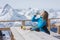 Woman snowboarder drinking water outdoors against a background o