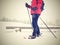 Woman snowshoeing in snow fall. Dark grey clouds