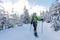 Woman snowshoeing in winter Carpathian mountains