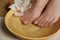 Woman soaking her feet in bowl with water and flower, closeup. Pedicure procedure