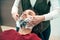 Woman soaping clients beard in barbershop