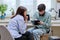 Woman social worker, mentor interviewing, talking to young male in office