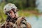 Woman soldier ready for battle wearing protective military gear and weapon