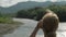 Woman solo tourist drinks coffee while relax on river and mountain background