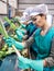 Woman sorting fresh leek in vegetable factory