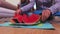 Woman sorting watermelon pieces on dish